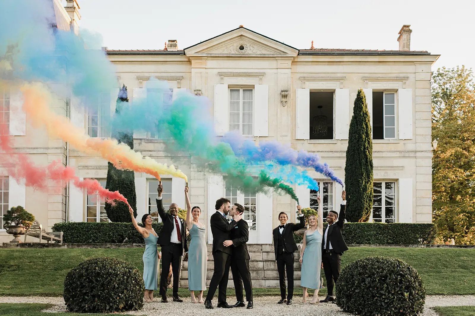 Gay wedding in a french castle group picture with rainbow flag