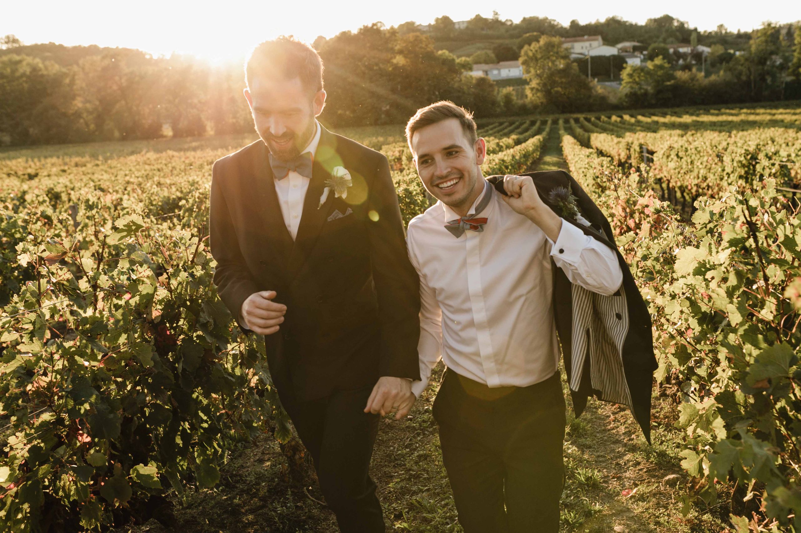 Gay couple in the french vineyard fields at sunset