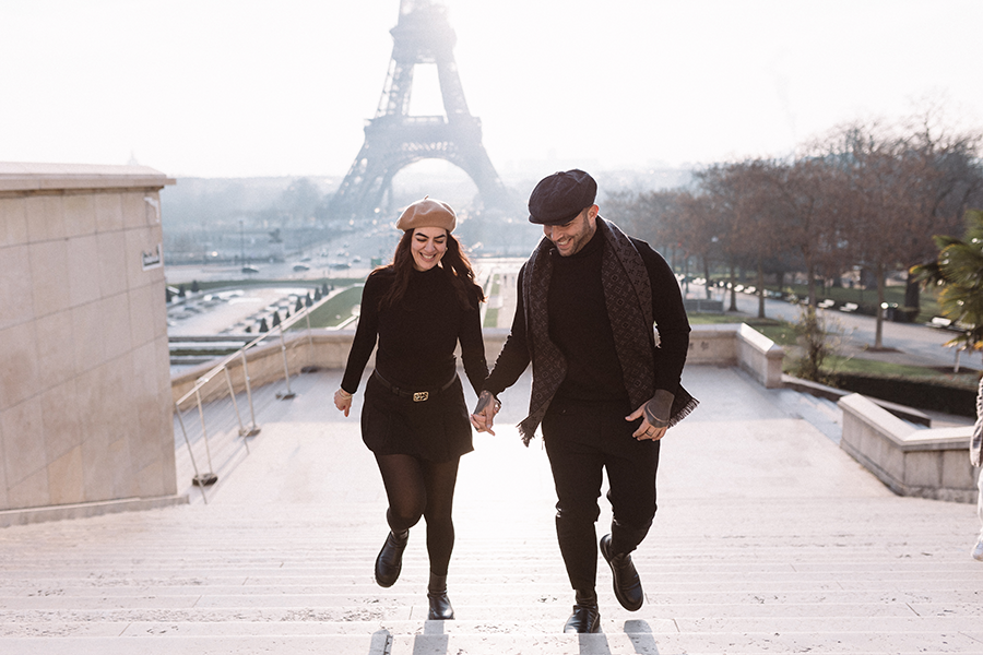 a couple in the stairs in front of eiffel tour
