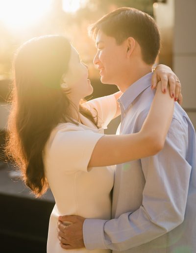 The couple holds each other closely in warm light during their Paris photoshoot.